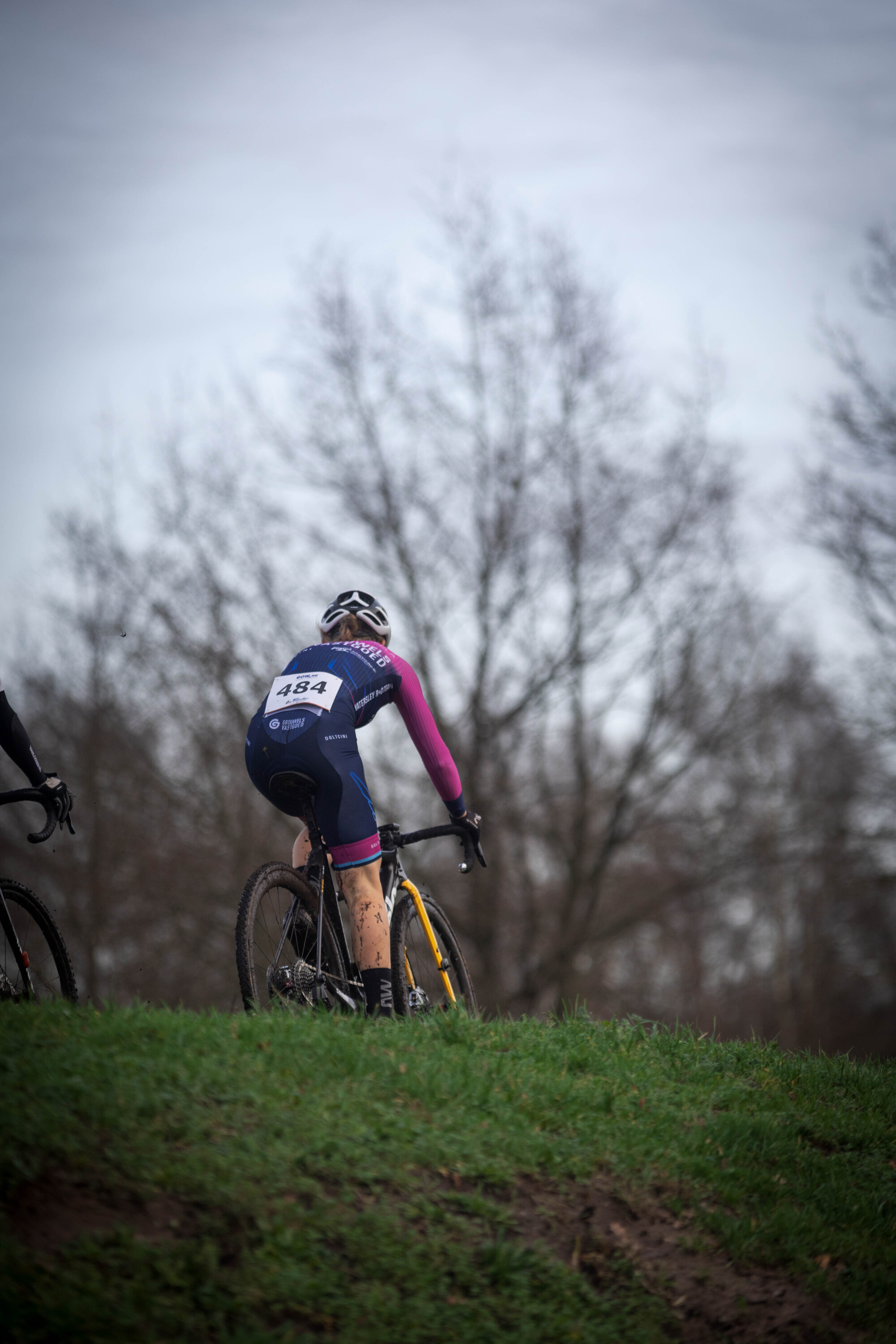 A person on a bike with the word GOW on their back and shorts.