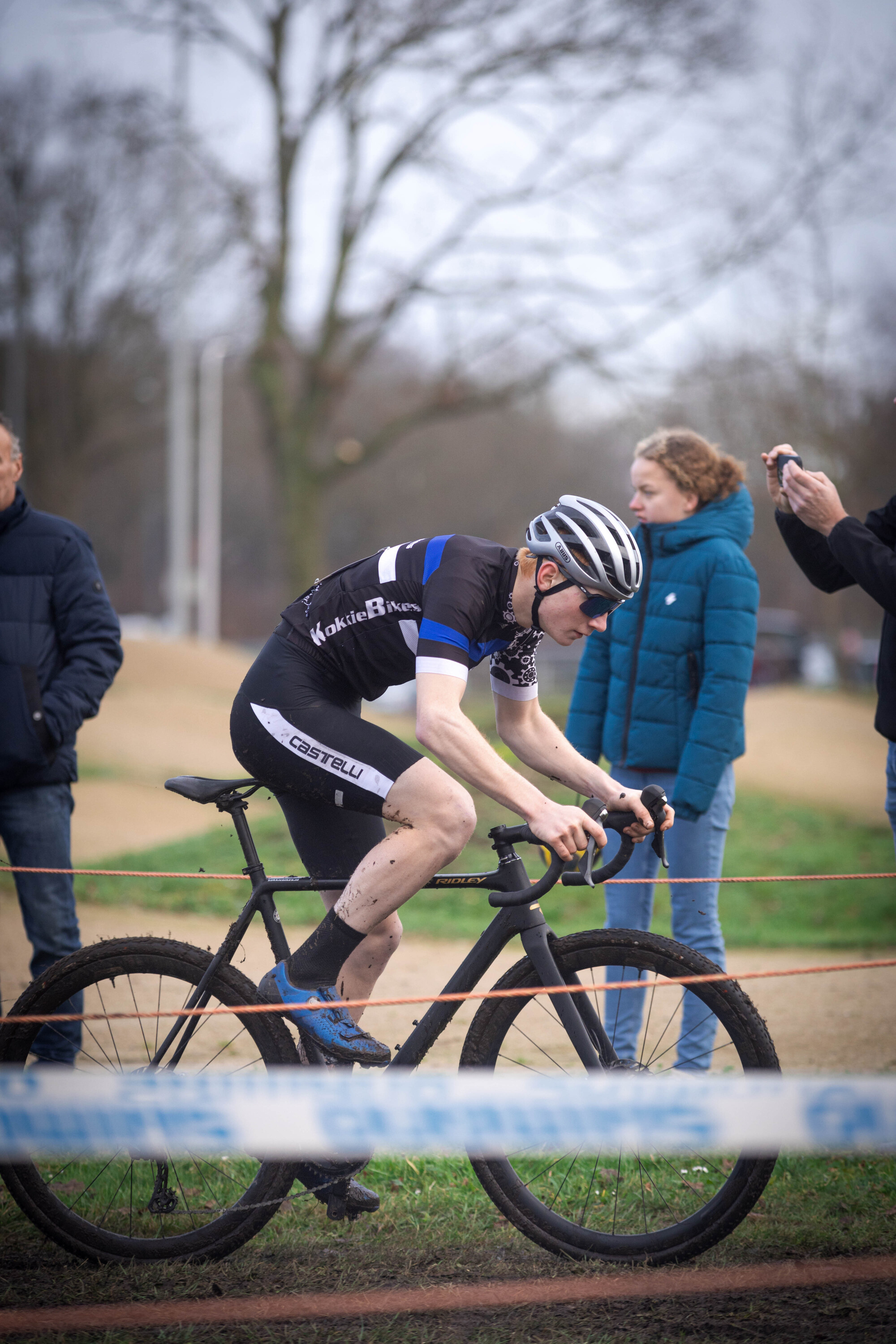 A man on a bicycle with the words Cyclocross written in blue.