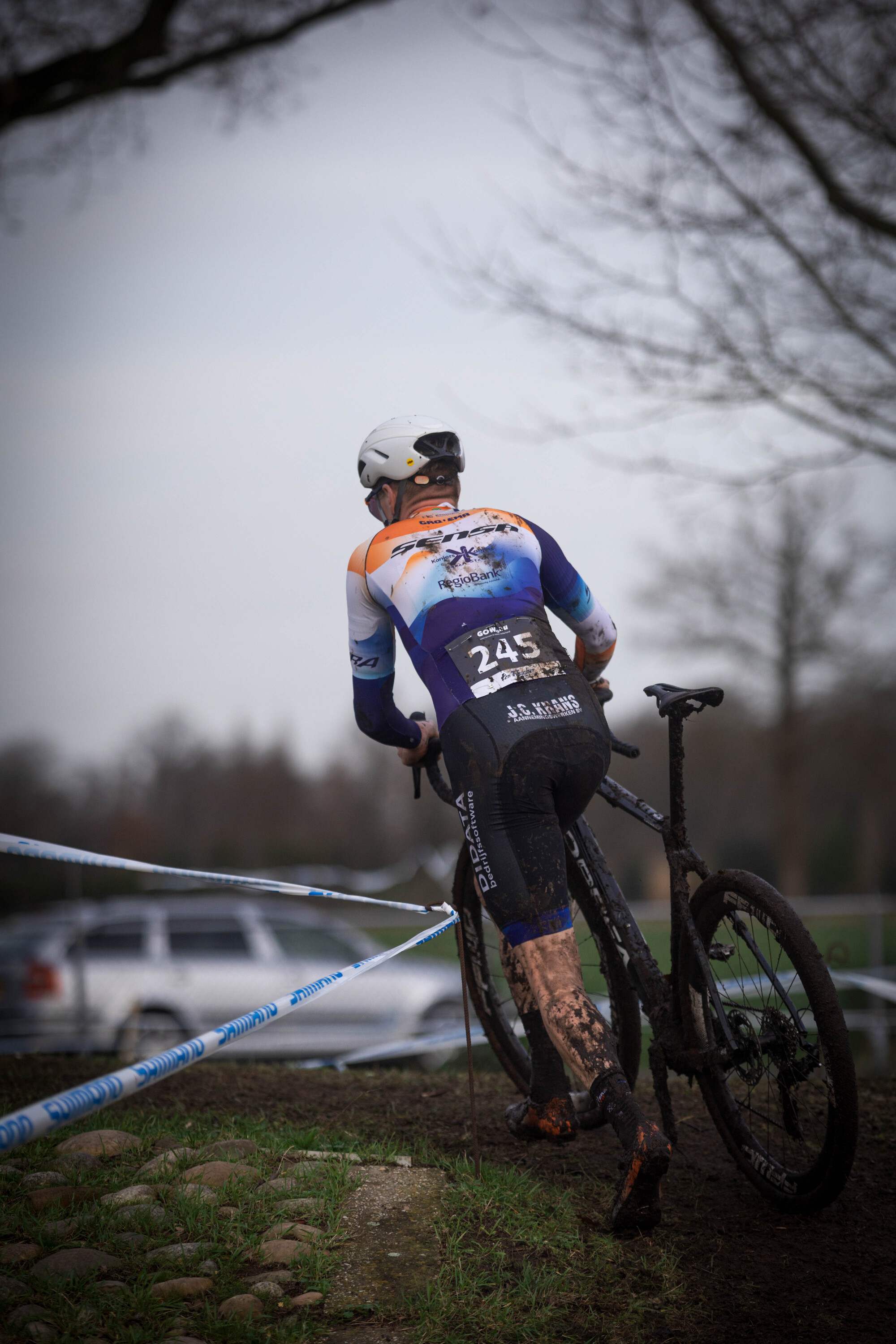 A cyclist wearing 201 and the number 2023 is riding a bike.