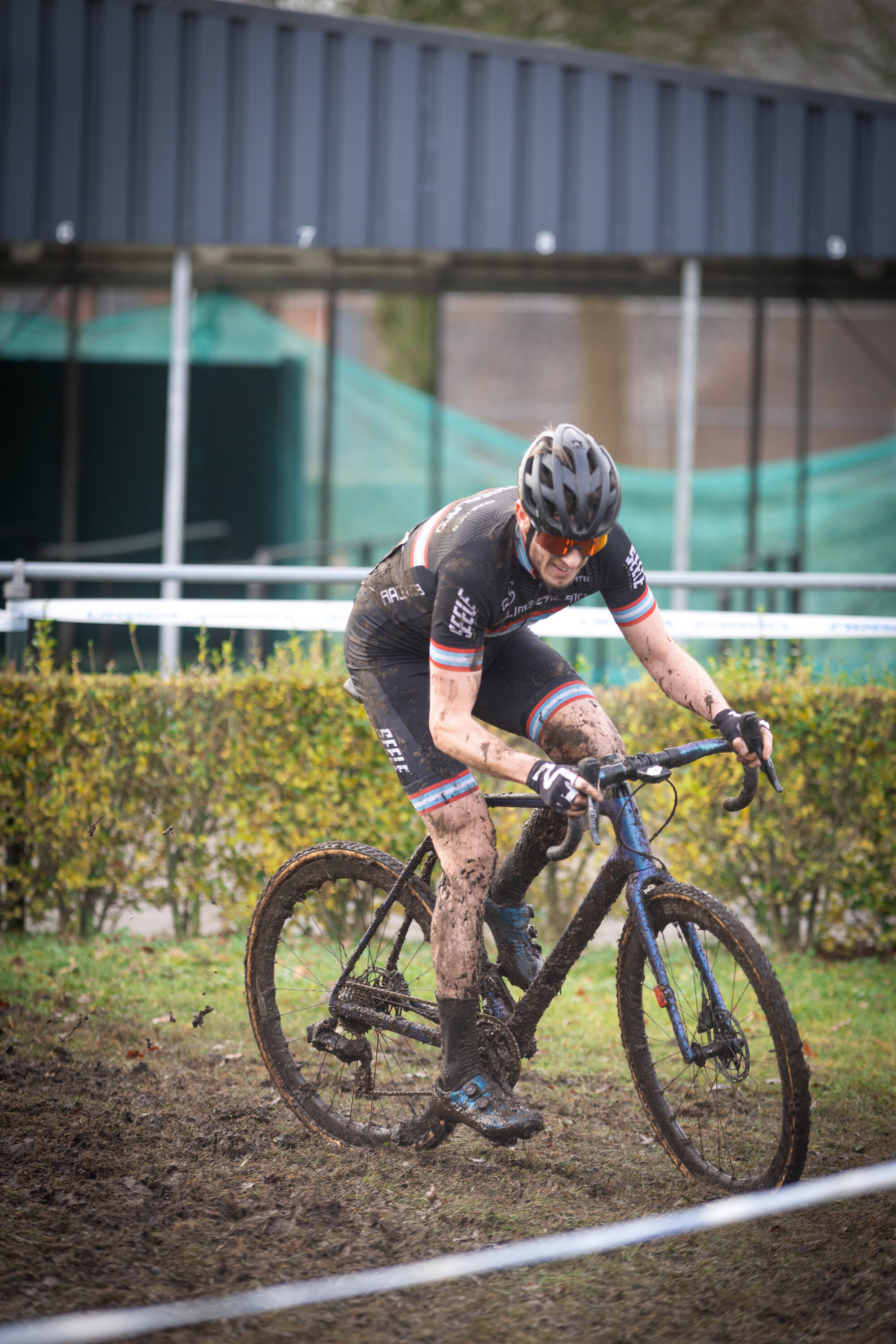 A person riding a bike with the word cyclocross in the back.