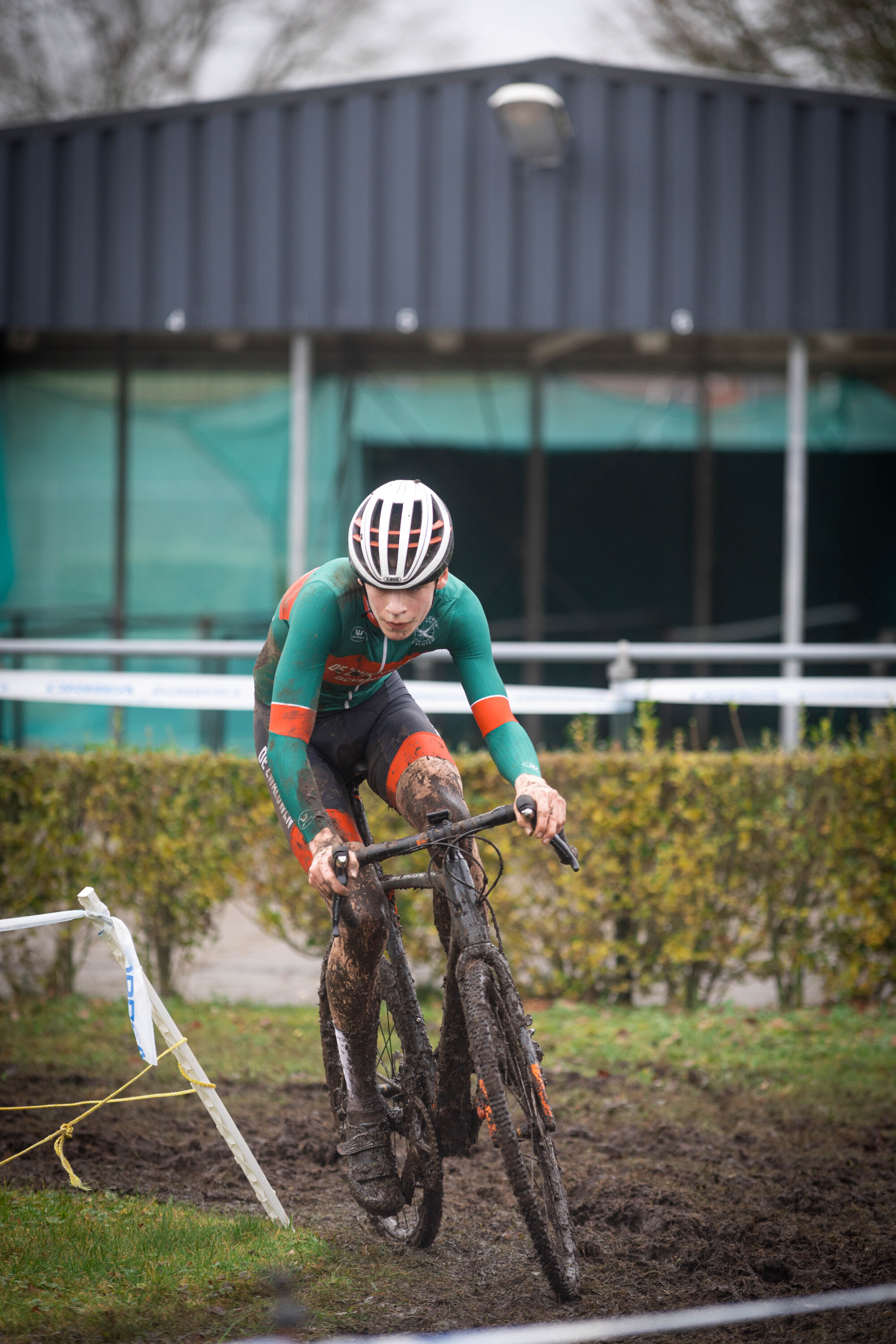 A man on a bike in a field with the words "Cyclocross" written above him.