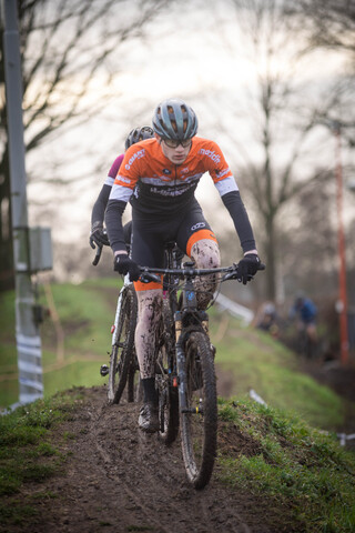 A person on a bike with the word cyclocross on their top.