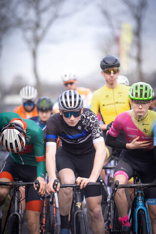 A group of cyclists are wearing GOW uniforms and helmets.