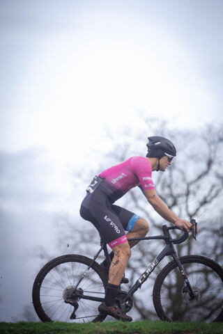 A person riding a bike with the number 1 on the back of their jersey.