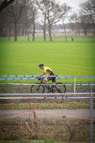 A person is riding a bike across an area of green grass.