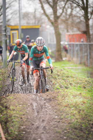 A group of people are riding their bikes in a cyclocross race.