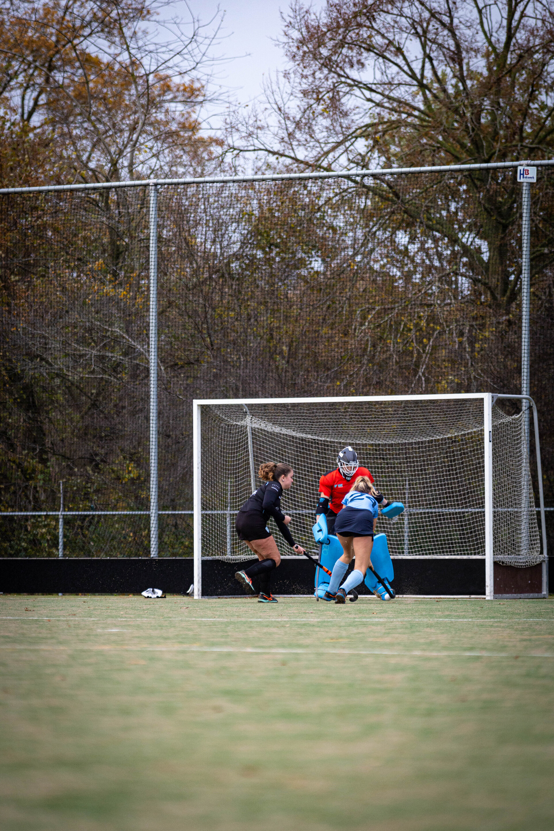 A hockey game is in progress and the referee is making a call.