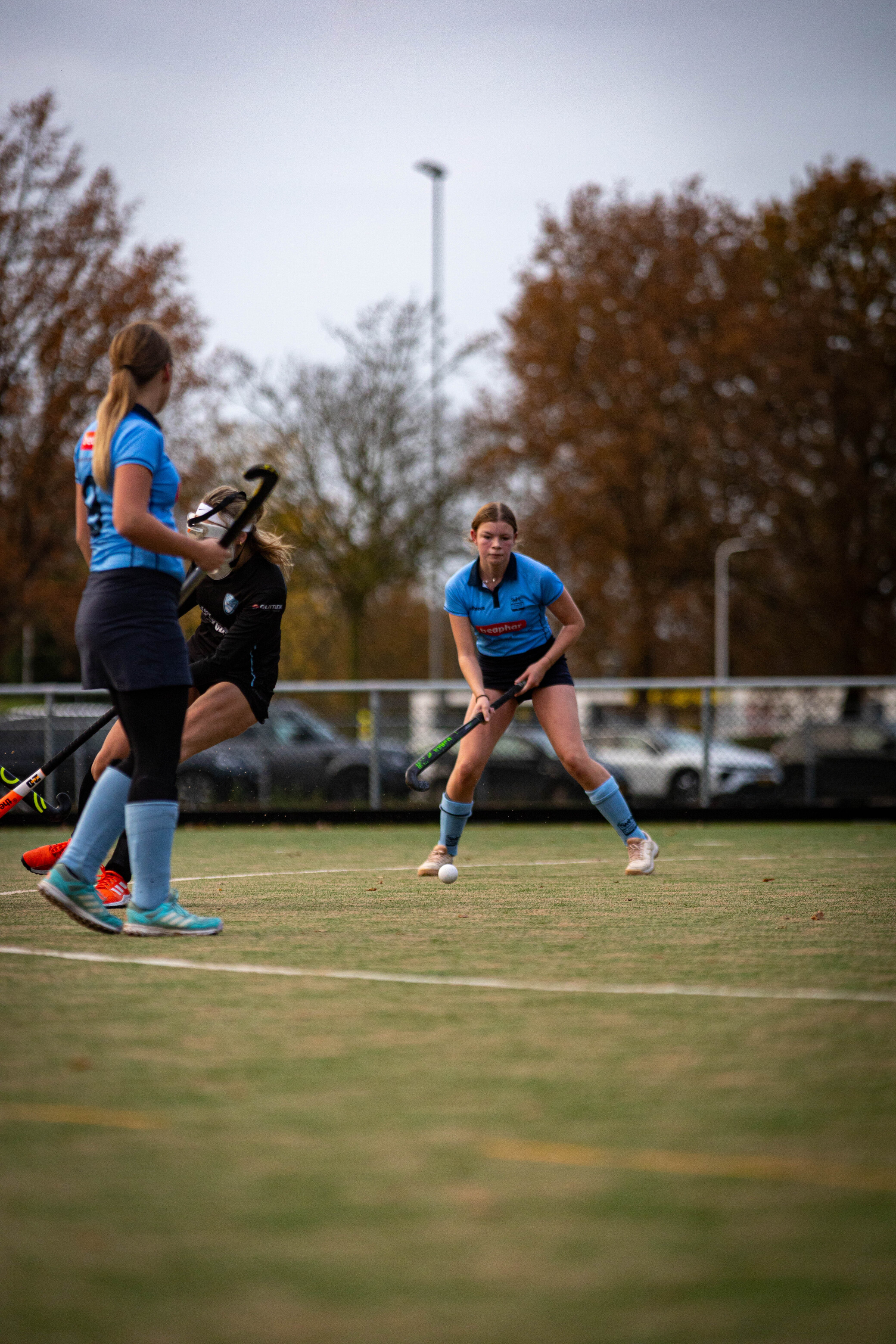 Two women playing soccer with one wearing the number 19 on her jersey.