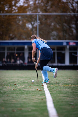 A hockey player in a blue jersey and pants on the field.