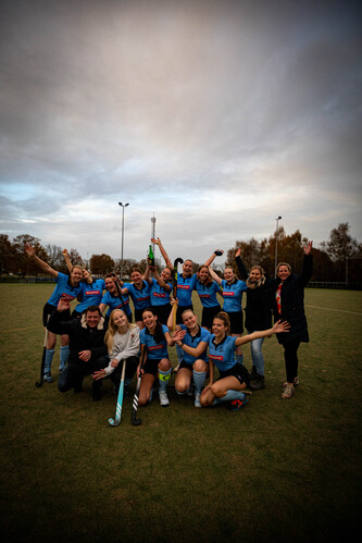 Team of sports players posing for a photo, celebrating their victory.