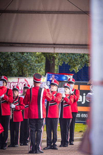 A group of people are playing brass instruments for a Kermis Boerhaar.