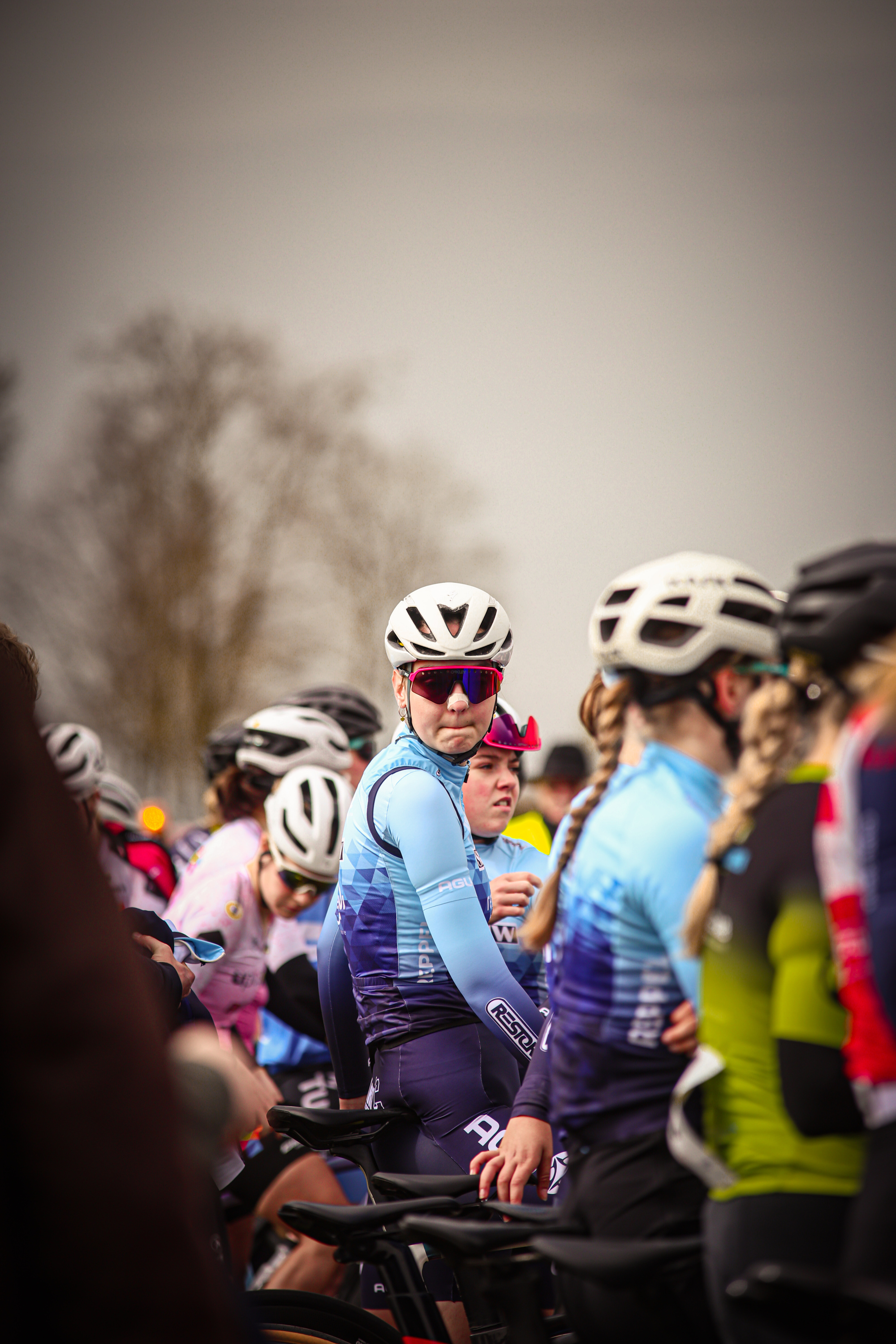 People wearing colorful bike suits are part of a cycling competition.