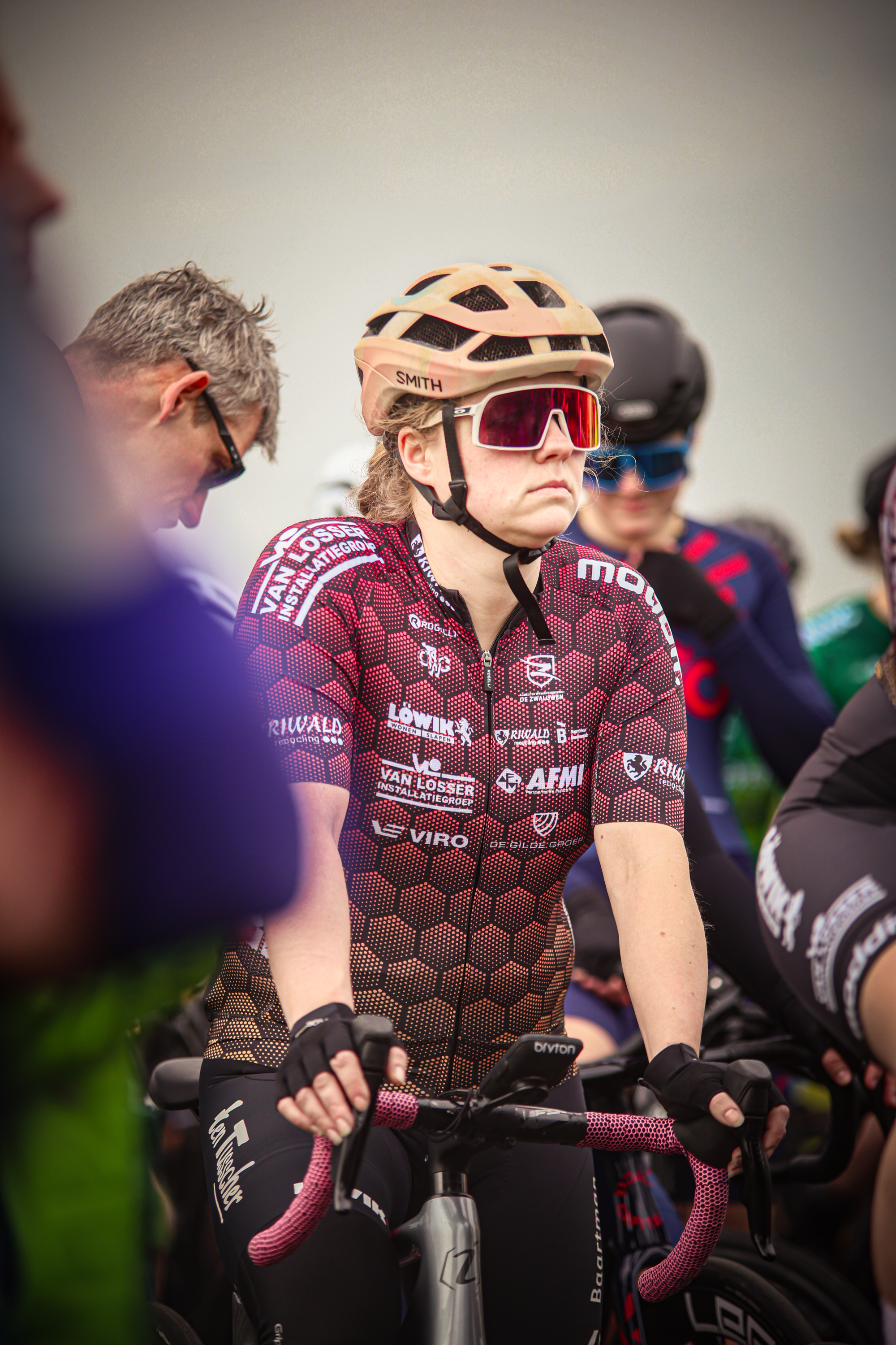 A group of women on bicycles with colorful jerseys.