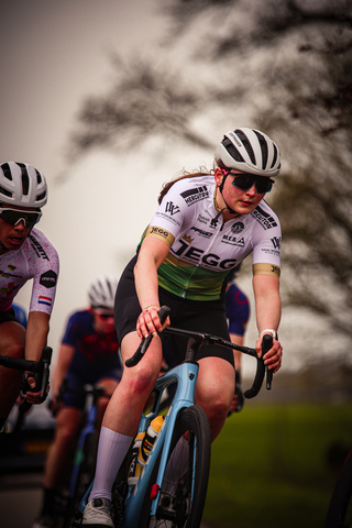 A group of women participating in a cycling race sponsored by Giant.