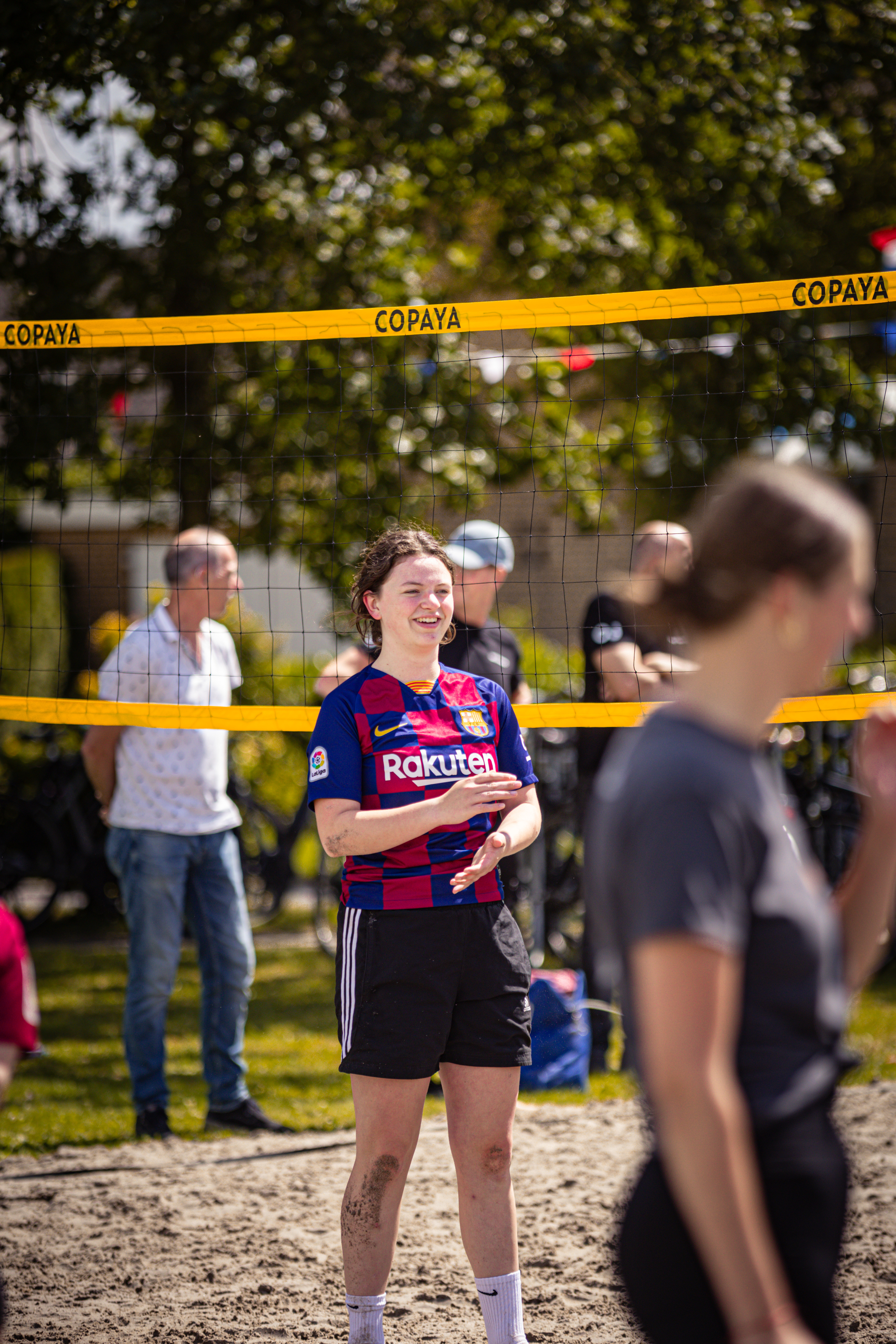 A woman wearing a red and blue jersey with the word "Rokkestad" written on it.