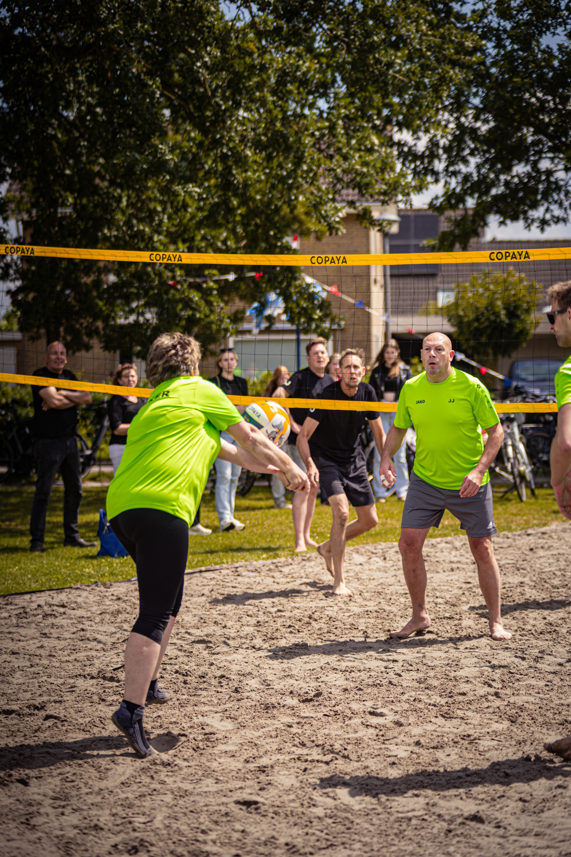 A man and a woman playing volleyball. The woman has the number 1 on her shirt.