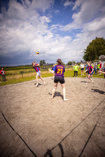 A group of people playing volleyball at a Kermis Boerhaar event.