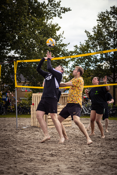 Boerhaar beach volleyball game with players wearing jerseys, shorts and playing barefoot.