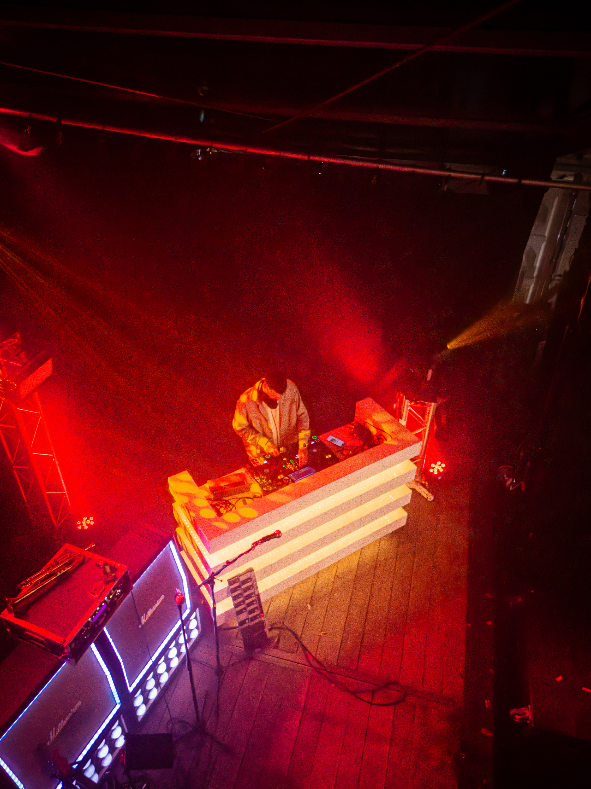 A man is playing an electronic keyboard on a stage.