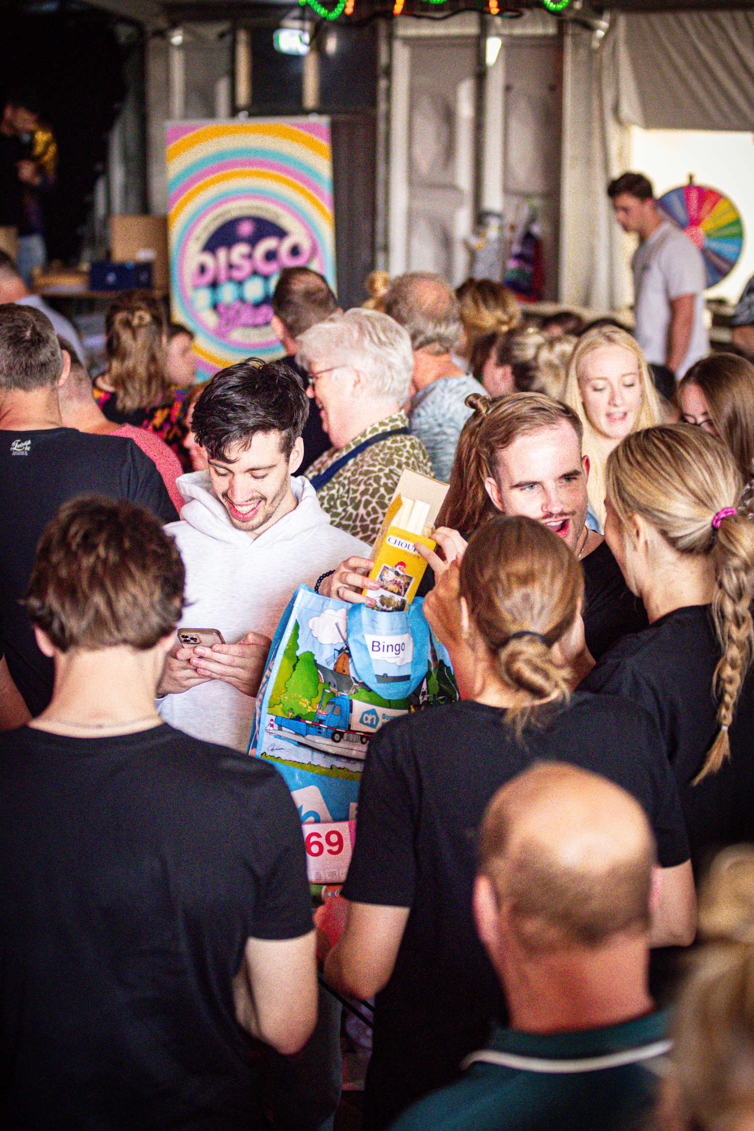 A group of people are dancing and posing for a picture at the disco.