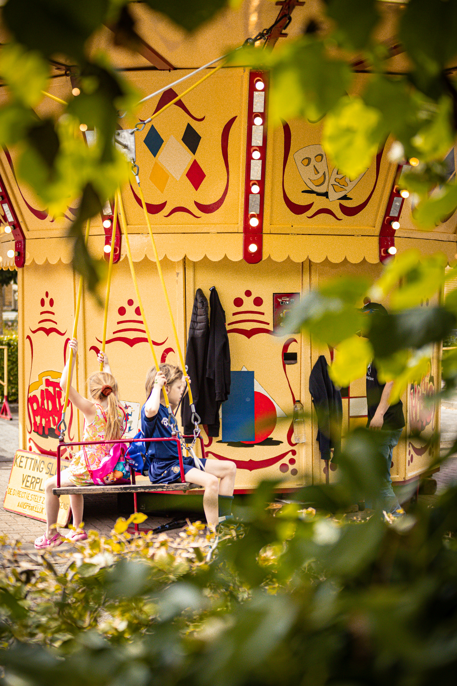 A woman is seen on a merry-go-round at an outdoor carnival.