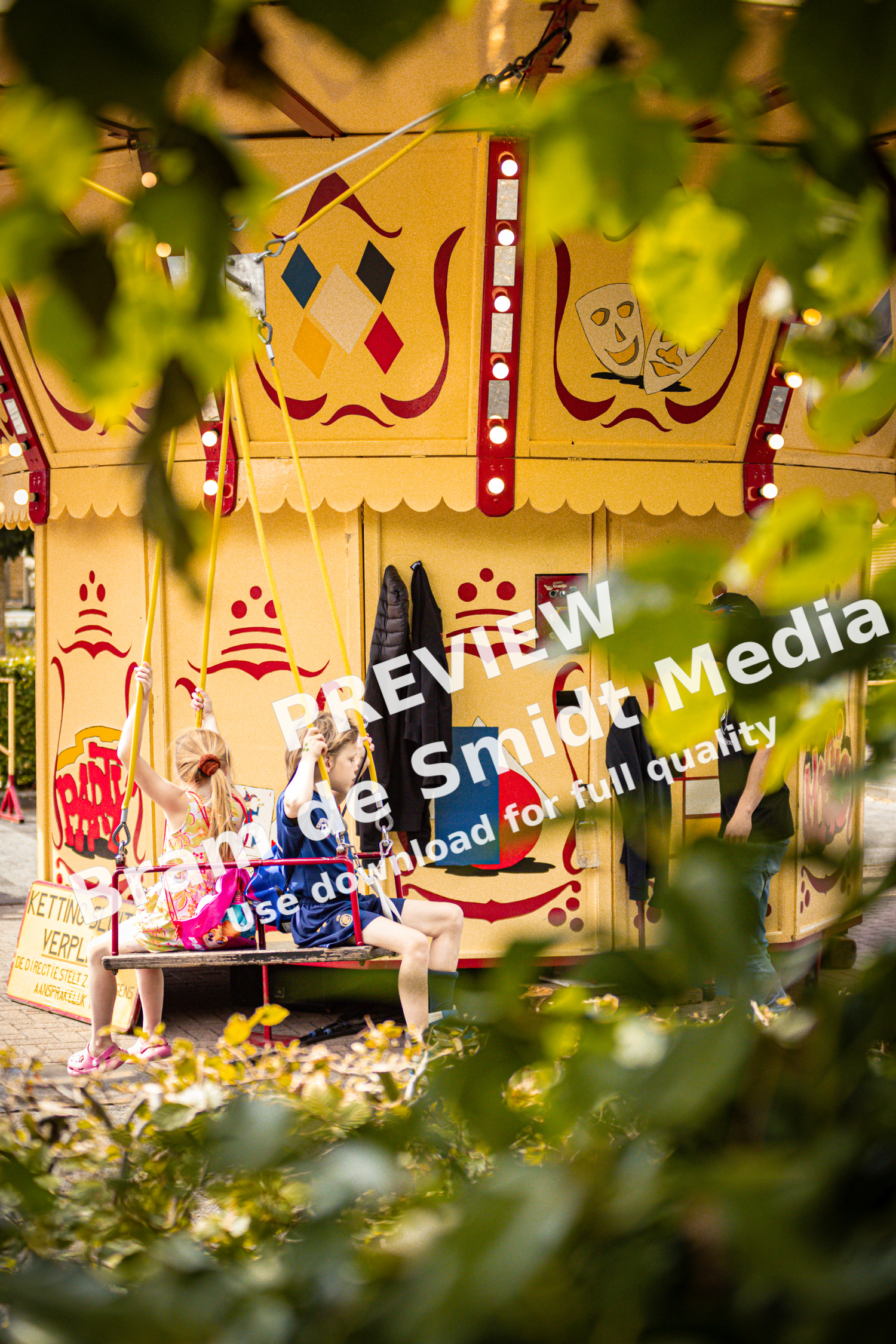 A woman is seen on a merry-go-round at an outdoor carnival.