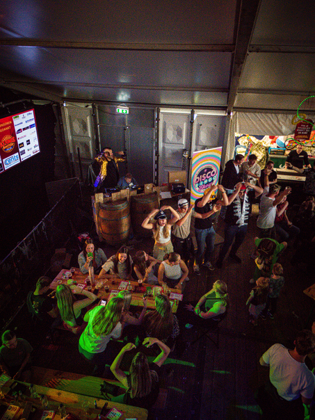 A group of people sitting around a table in an indoor bar.