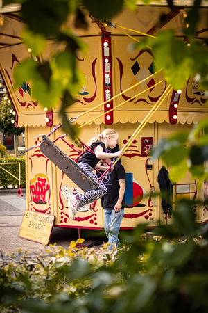 Two people are seen enjoying a carnival ride on Kermis Boerhaar.