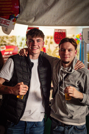 Two friends at a carnival called Kermis Boerhaar, having fun and enjoying themselves.