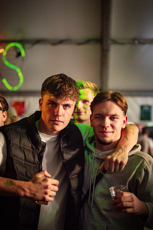 "Two young men posing for a photo at the Kermis Boerhaar, enjoying their time at Middag & avond."