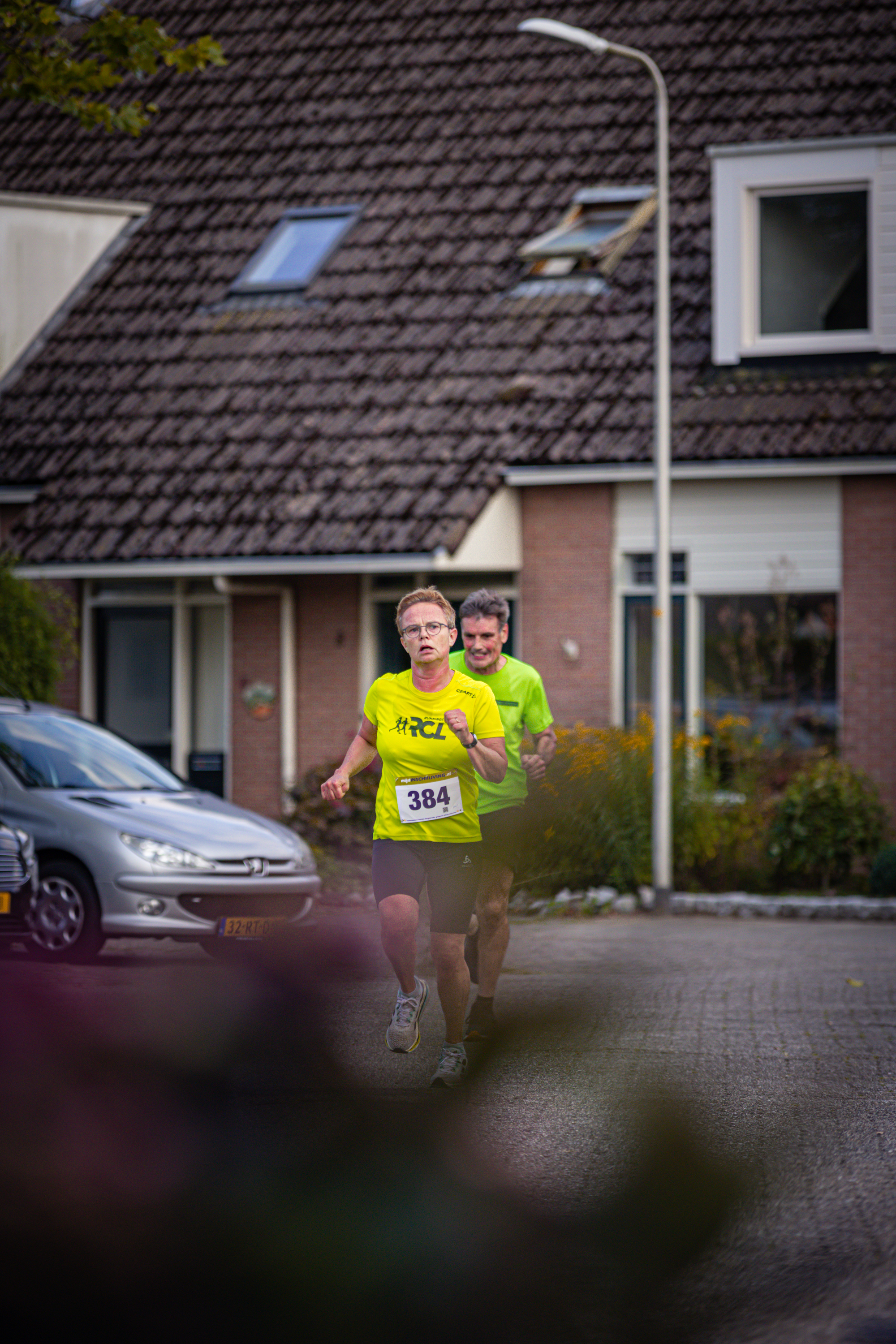 A couple running a race with bib numbers 38 and 39 on.