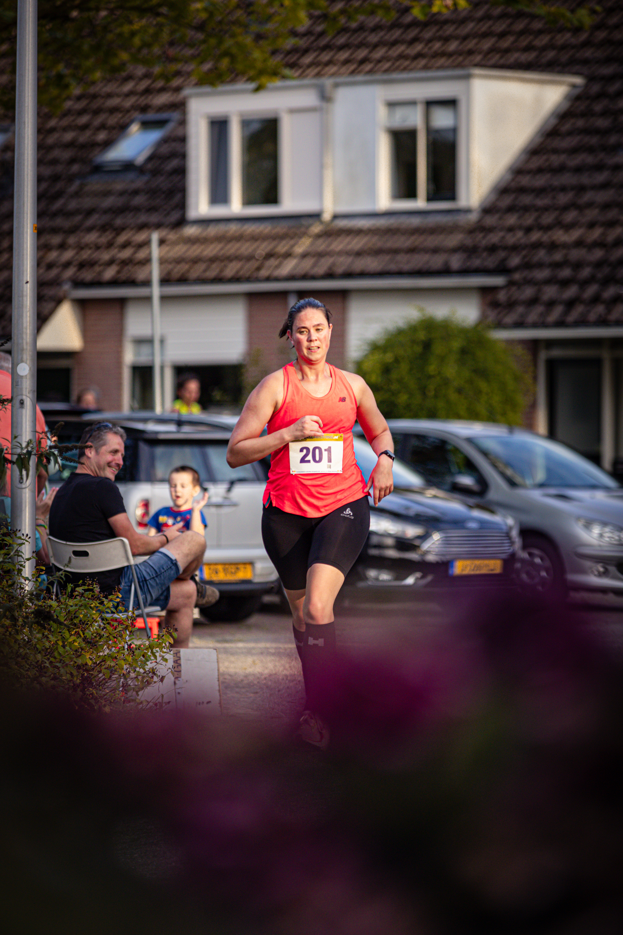 A girl running in a park with the name Pomplop on her shirt.