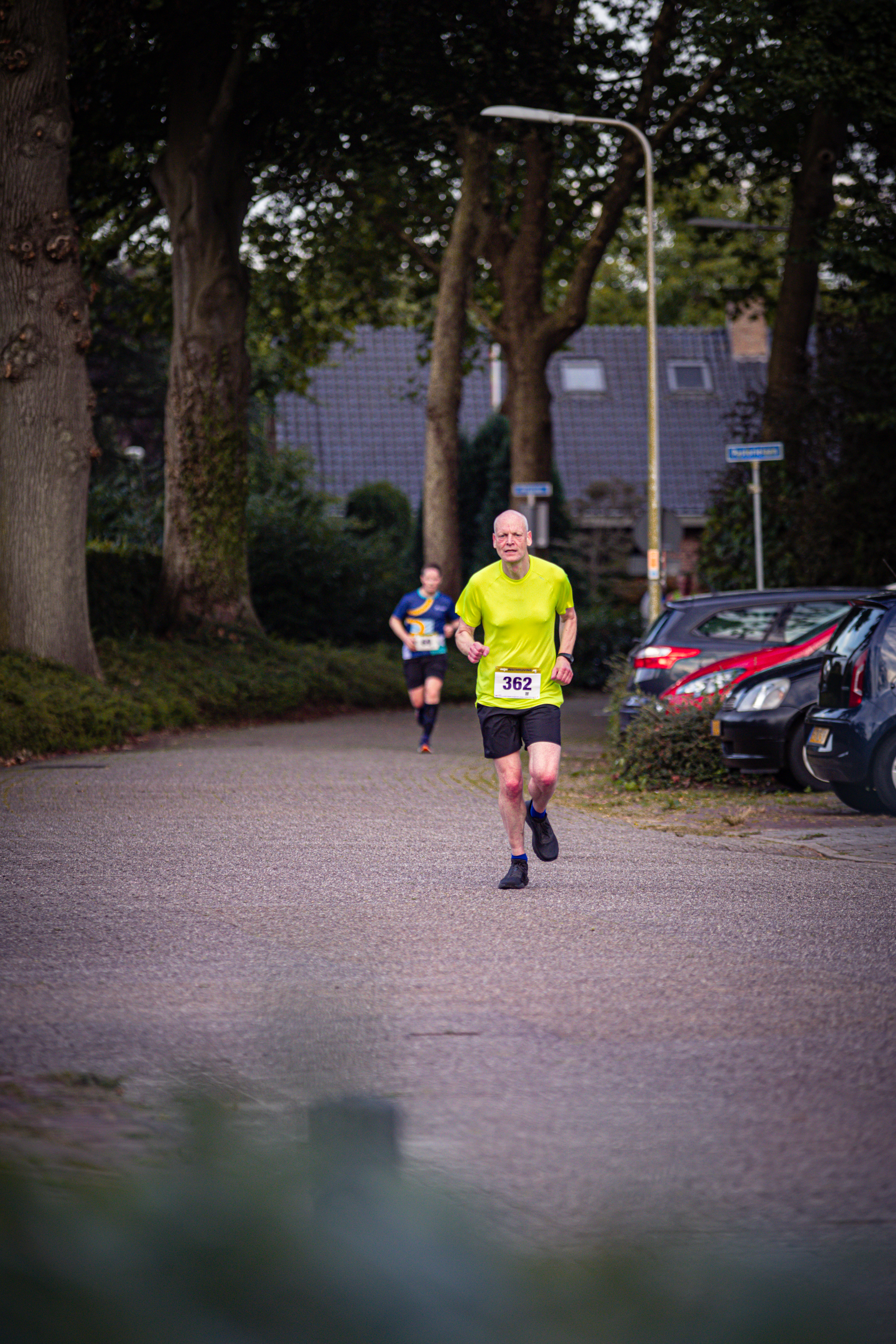 A runner is wearing a shirt with the number 28 on it.