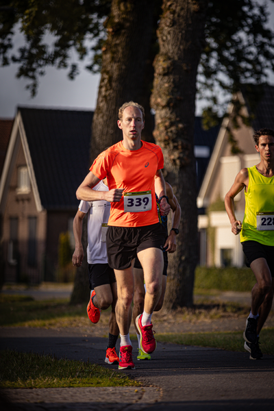 A photo of a race with number 339 leading the way and two others chasing him.