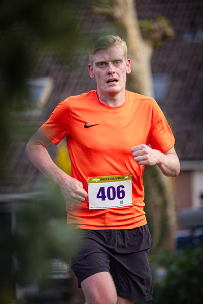 A person in an orange shirt with a white number 406 on it.