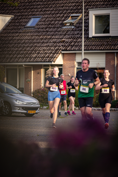 A group of runners participate in a race, sponsored by Nike.