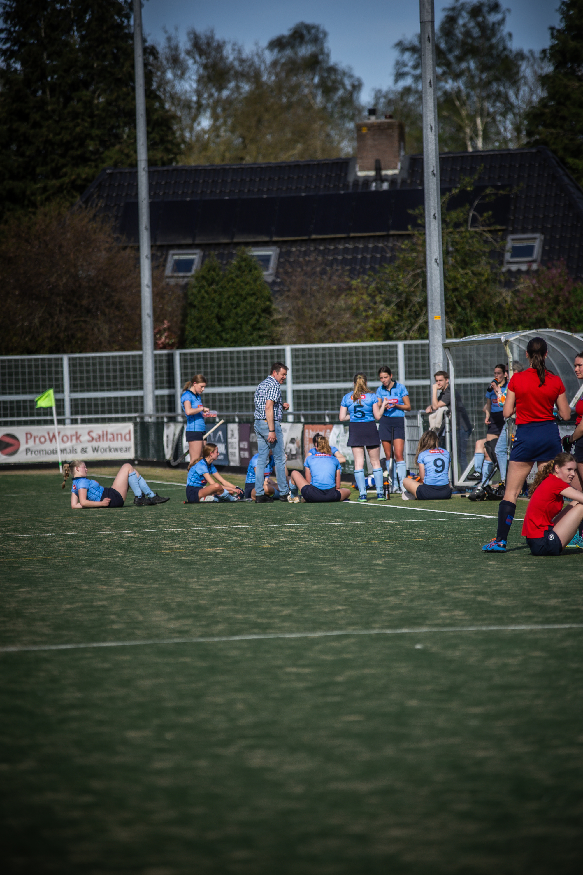 A group of hockey players on a field in 2024. The team is wearing blue and the team's name begins with SMHC.