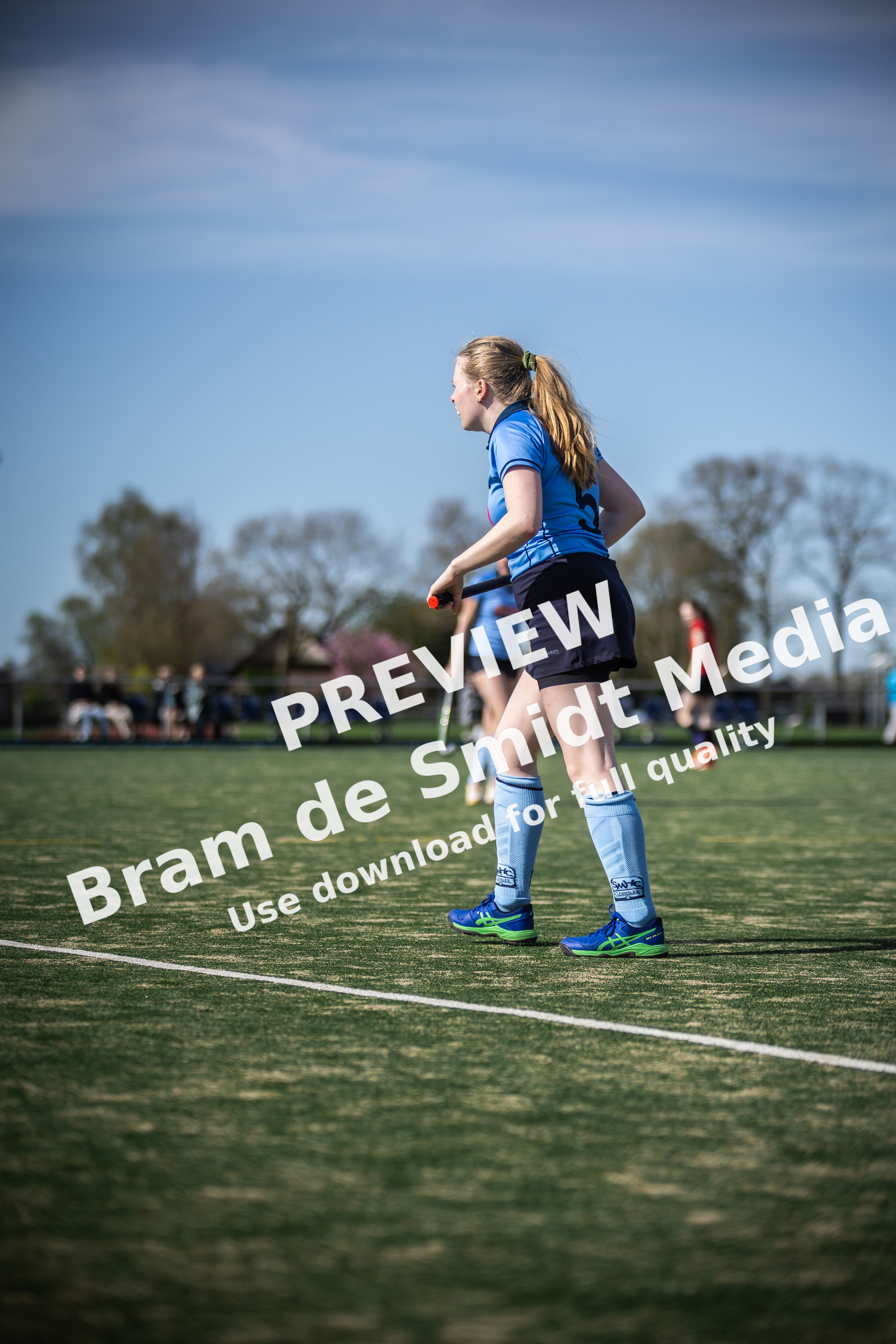A young girl is getting ready to play in a girls hockey game.