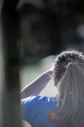 A woman is wearing a blue shirt advertising Bet365.