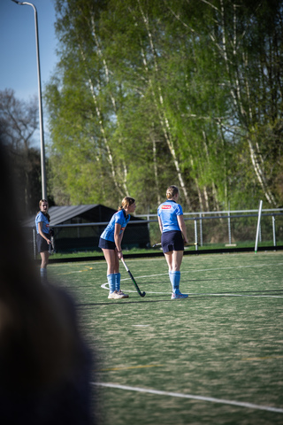 A team of female hockey players from SMHC are practicing on the field.