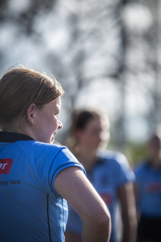 A woman in a blue shirt with Family too on the back.