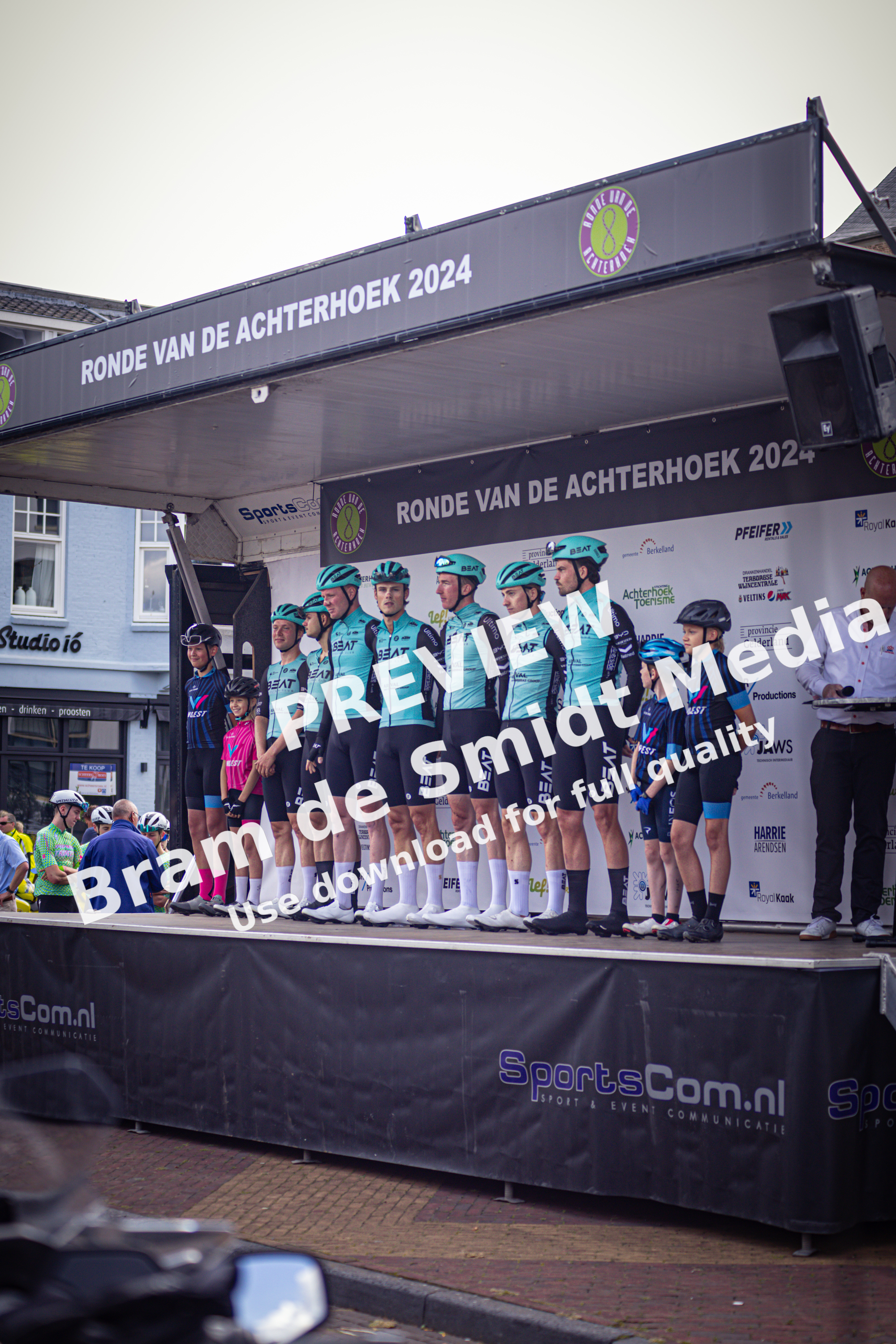 A group of cyclists standing on a platform at the Ronde van de Achterhoek 2024.