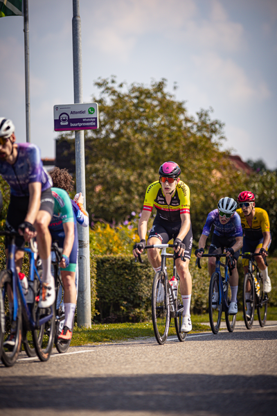 Group of cyclists in a race that is sponsored by a bank.