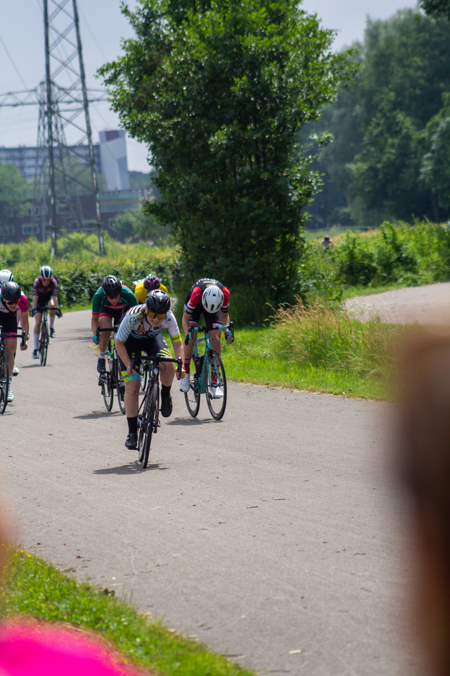 Four cyclists participating in a race with the one on the front leading.