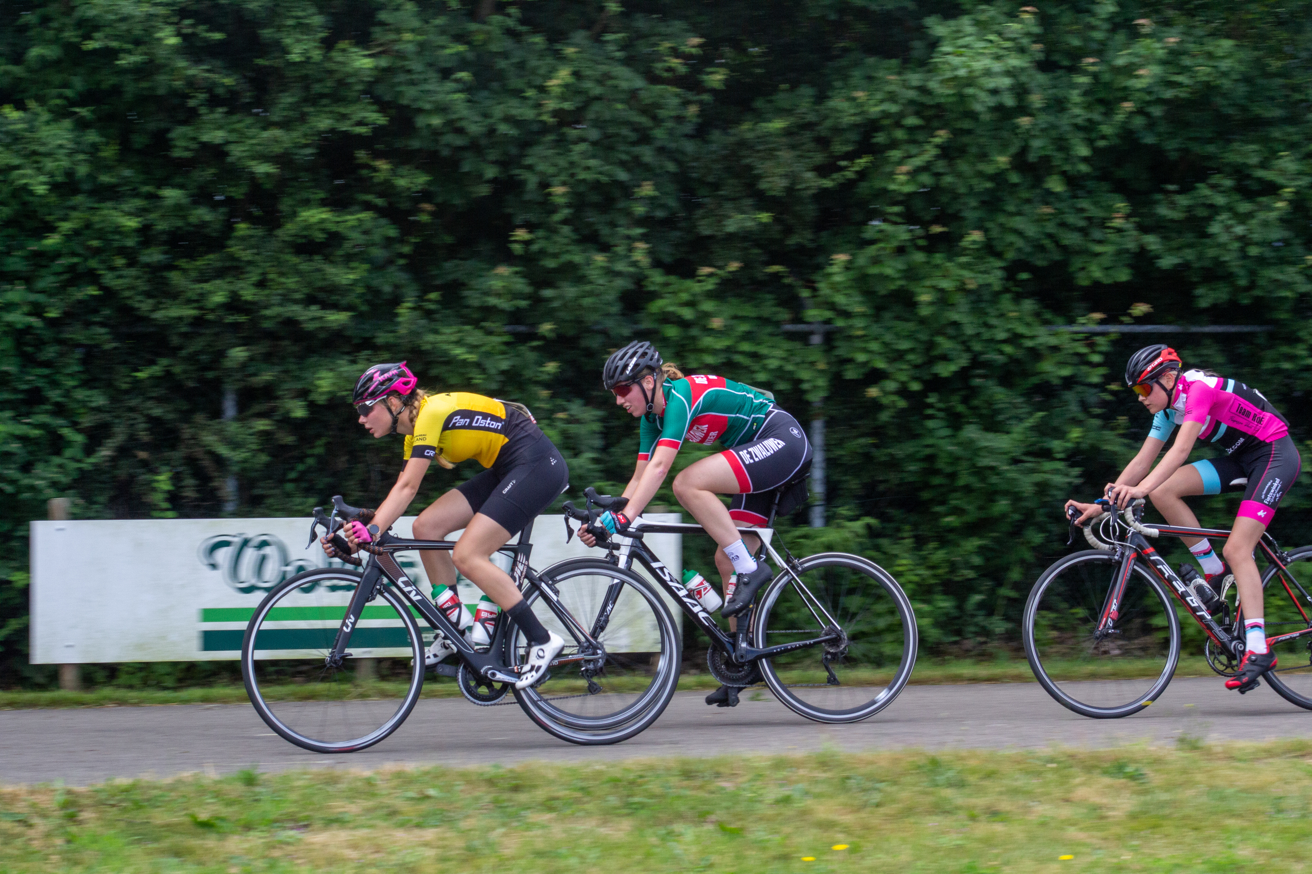 Four cyclists race down a road during the Dames ronde van Deventer.