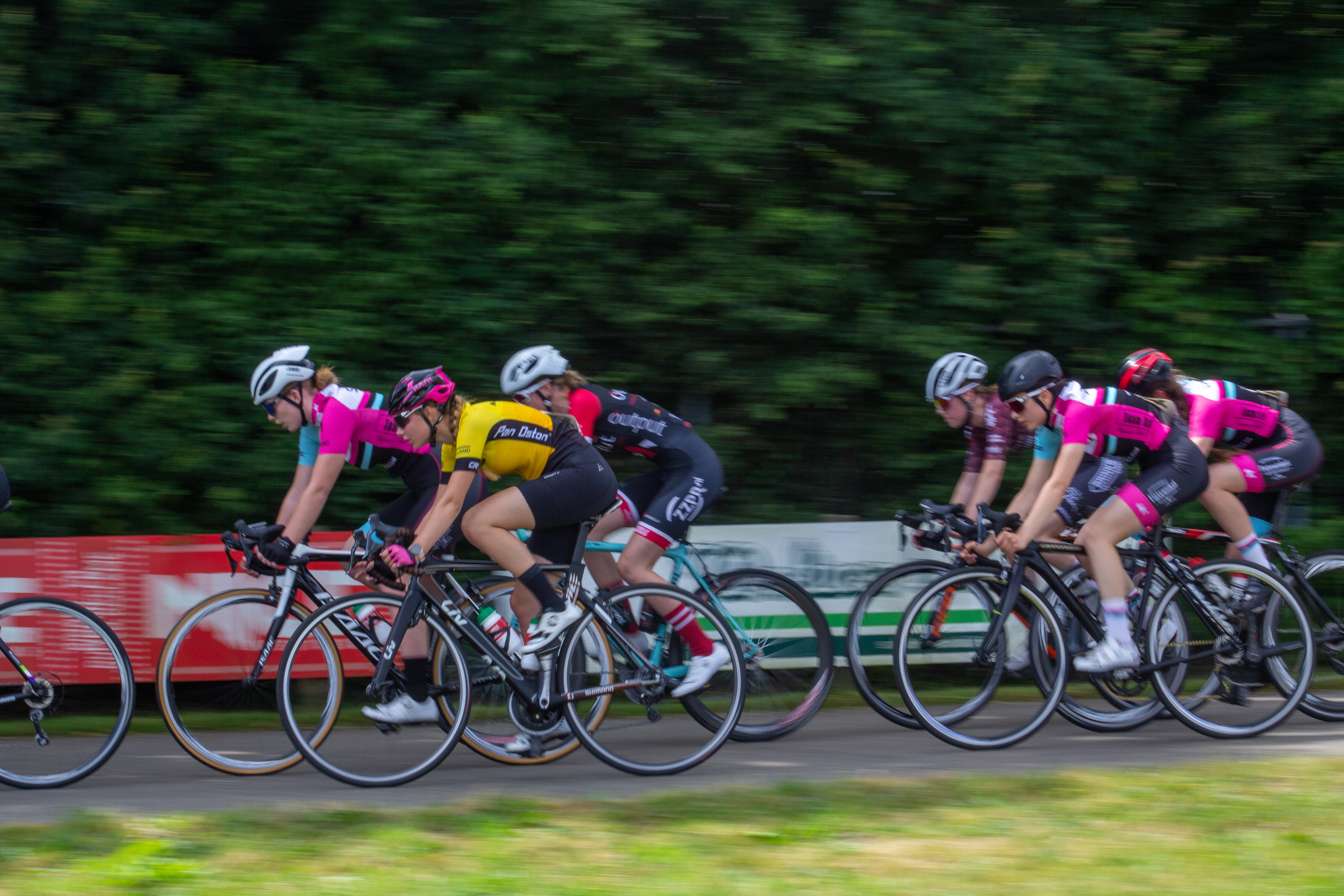 Women riding bicycles in a group race sponsored by Gatorade.