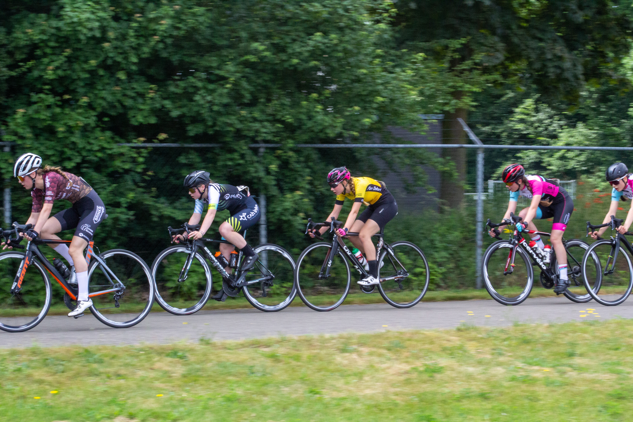 A group of women on bicycles participate in the 2021 Dames Ronde Van Deventer race.