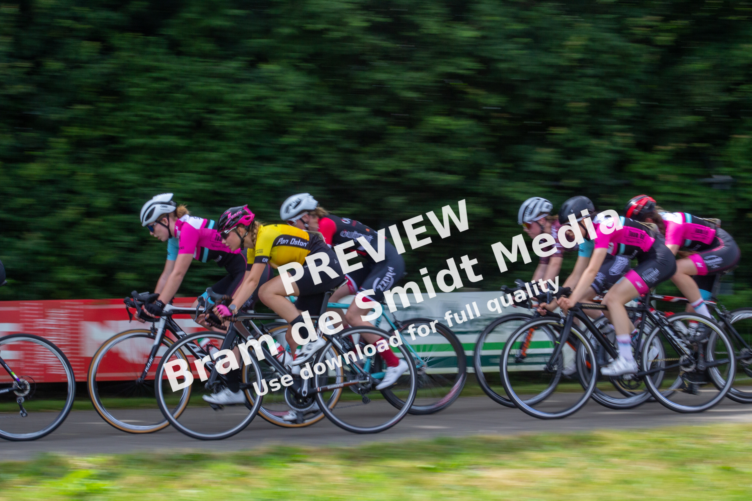 Women riding bicycles in a group race sponsored by Gatorade.