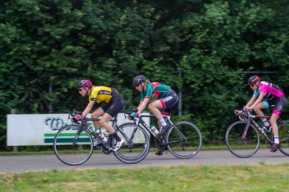 Four cyclists race down a road during the Dames ronde van Deventer.