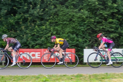 A group of cyclists ride on a race track for the Dames Ronde Van Deventer.